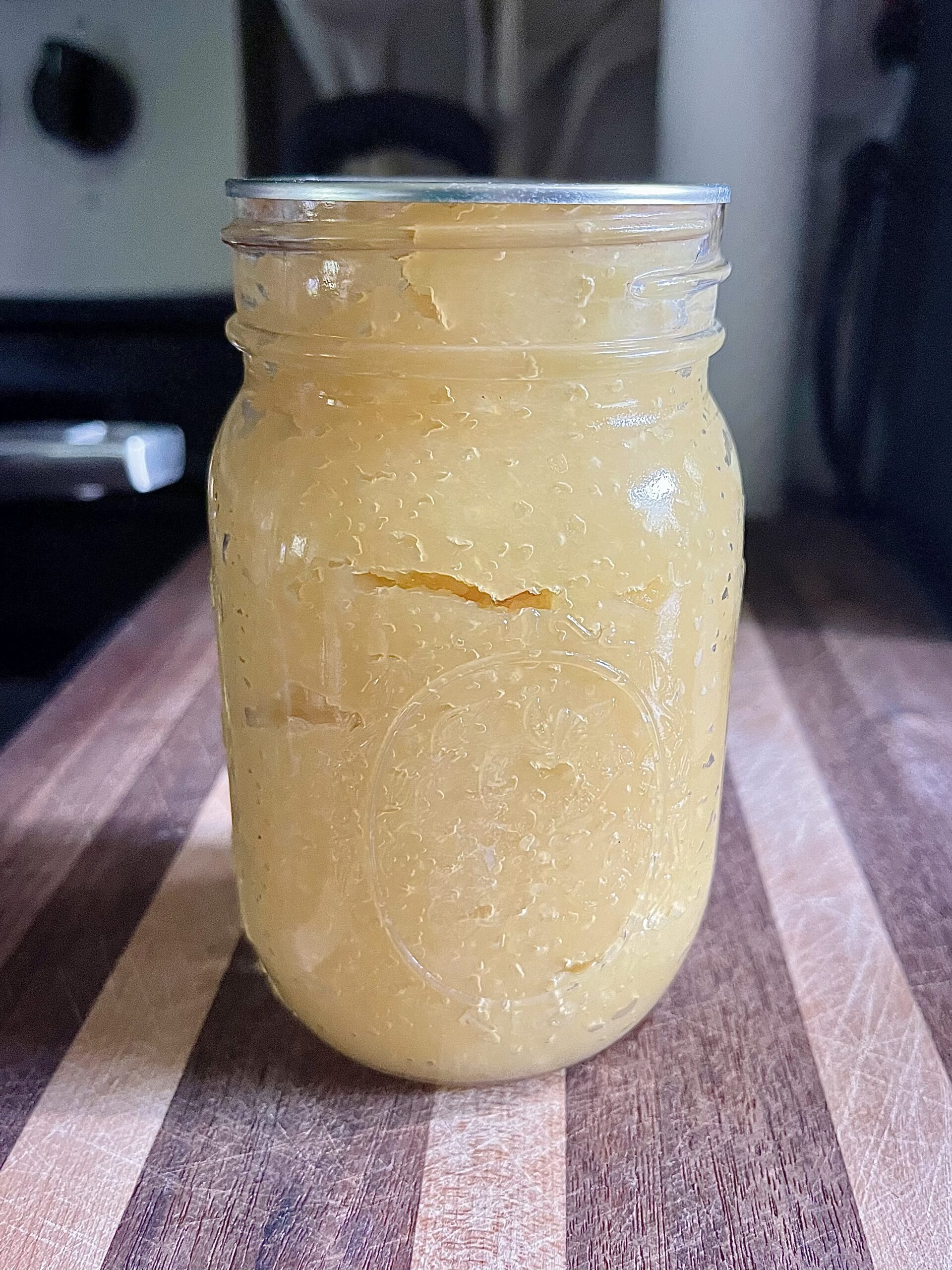 Homemade applesauce in a sealed jar after water bath canning.